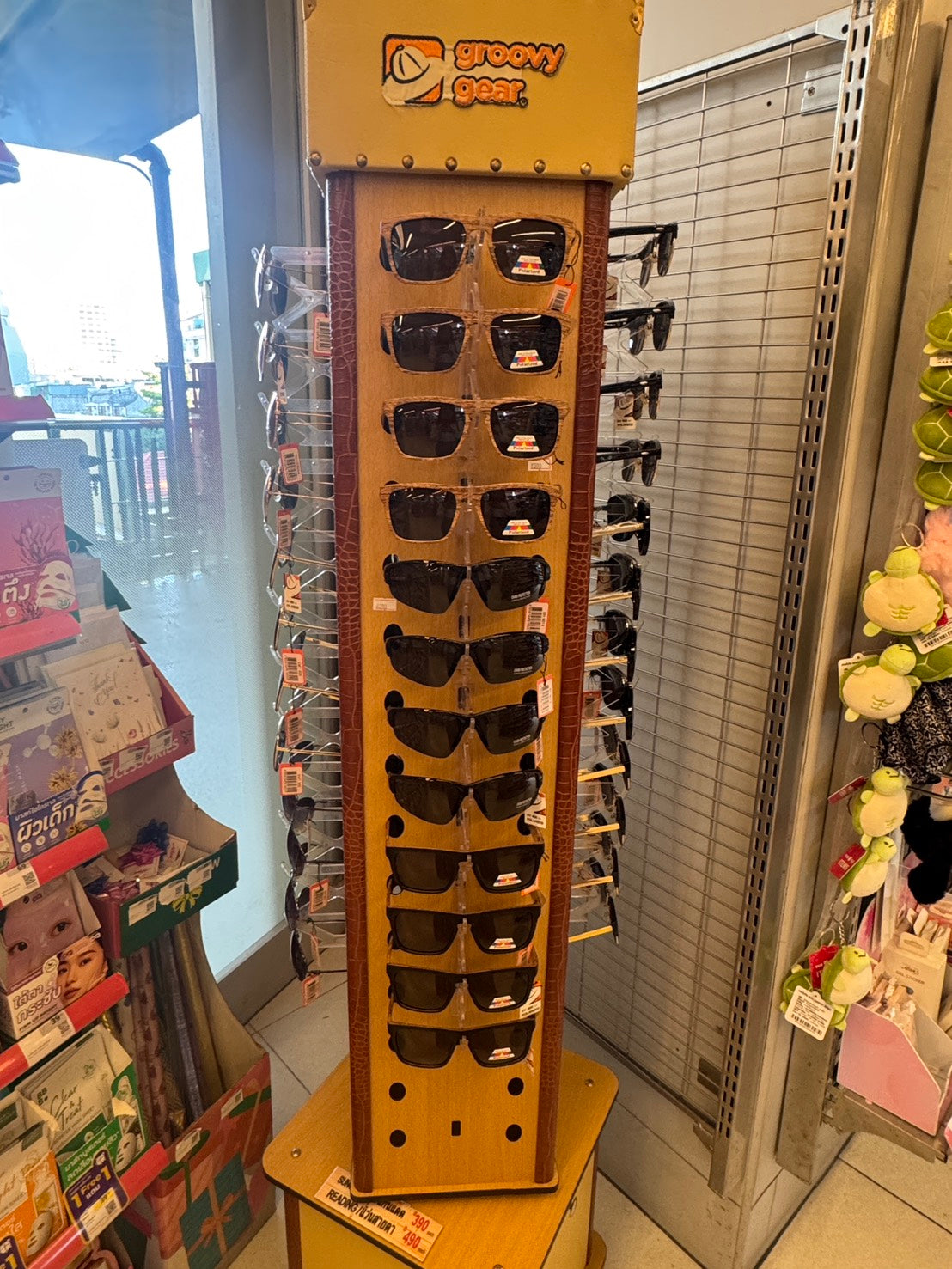 Front view of the Groovy Gear sunglasses spinner in a retail store